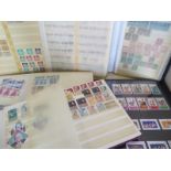 Eight stamp albums of different sizes with British and international stamps, also some first-aid