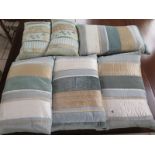 Six Laura Ashley cushions, all rectangular in form, four large approximately 55cm wide and two