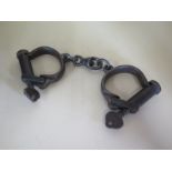 An Ex-Military antique cast iron Darby Handcuffs with two keys - Authentic - dated 1952, has the