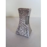 A retro Dunhill table lighter, with hammered bark effect casing, and of a waisted capstan form,