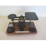 A set of brass postal scales with weights