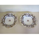 A pair of early 19th Century Chamberlains Worcester armorial dishes - 27cm diameter, crack to one,