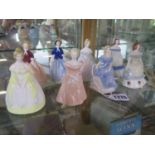 Eight Wade My Fair Lady porcelain figurines, approximately 9.5 cm high, all in good condition,