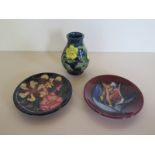 Three pieces of modern pieces Moorcroft pottery, a small buttercup pattern vase approximately 9.