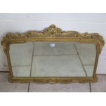 A 20th Century embossed gilt over mantle mirror, 66cm H x 89cm W
