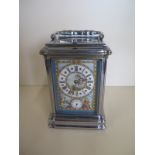 A carriage clock with alarm striking on a gong, with porcelain dial and panels, 15cm tall, with