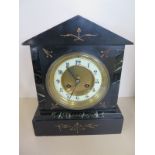 A slate 8 day striking mantle clock with key and pendulum - 36cm tall, ticks but stops