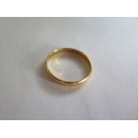 A 22 carat gold band, ring size approximately U/V, approximately 3.3 g