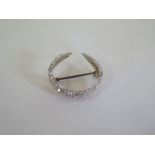 A yellow and white metal crescent shape brooch set with graduating diamonds, 25mm wide, approx 4