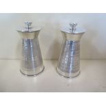 A pair of silver cased pepper mills, 10cm tall, some usage but generally good