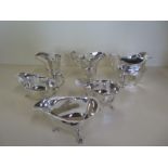 A pair of silver sauce boats, another sauce boat and two silver cream jugs, total weight approx 15