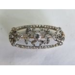 An Art Deco diamond brooch set in white and yellow metal, the central diamond approx 0.25ct,