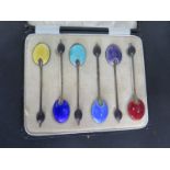 A boxed set of six silver enamel coffee spoons, approx 1.5 troy oz, two have chipped enamel, rest