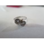 An 18ct white gold two stone diamond crossover ring - each diamond approx 0.90ct - ring size - J/K -