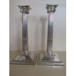 A matched pair of George III silver candlesticks by Emick Romer London 1764 - and Robert Jones and