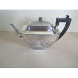 A Victorian silver teapot with ebony handle and finial, engraved with a monogram, possibly R W M,