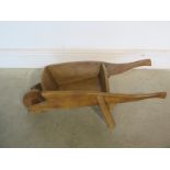 An ornamental wooden wheelbarrow suitable for use as a planter 76cm long - in good restored and