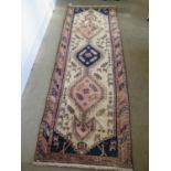 A hand knotted woollen Azarabaijan rug - some old wear and repair - 2.8m x 1m