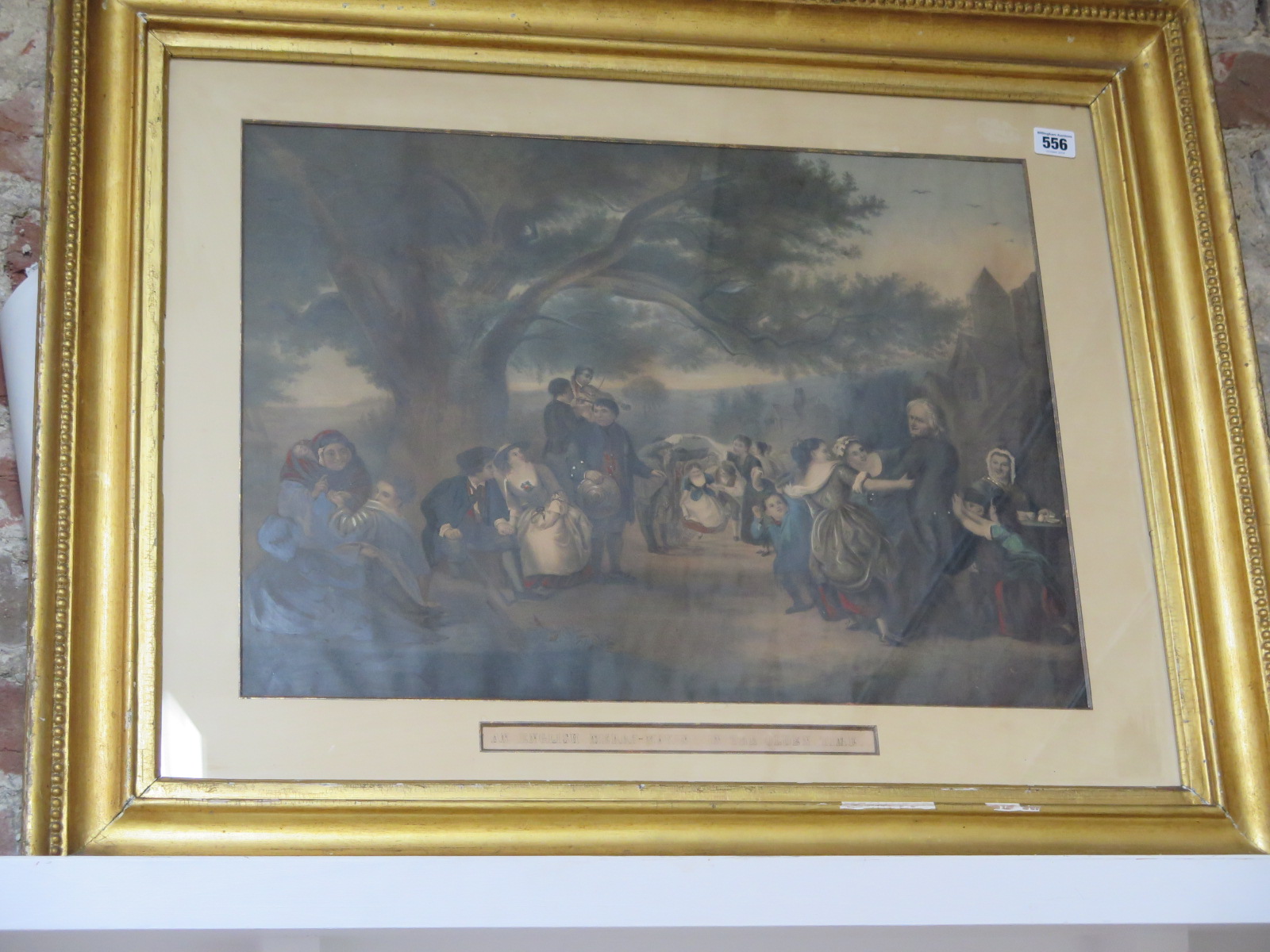 A coloured lithograph entitled - An English Merry Making in the Olden Time - in a gilt frame,