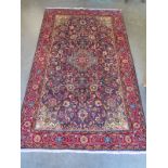 A red ground Kashmir and rug, approximately 214 cm x 132 cm, in good condition