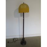 A very unusual 1920s standard lamp and shade, bronzed metal column finishing in a cast iron base