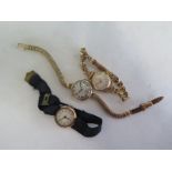 Three 9ct yellow gold wristwatches, two with 9ct straps, one with a cloth strap, total weight approx