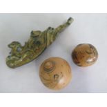 Two Eastern carved nut shells, largest 5.5cm and a bronze buckle