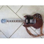 A Shafstbury Deluxe, SG style electric guitar, worn throughout