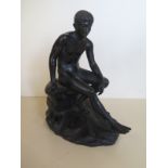 A bronze Greco Romano style figurine of a seated male nude, possibly Mercury, approximately 21cm