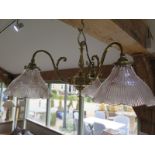 An Edwardian brass three branch centre light with holophane shades - 58cm wide - in clean condition