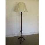 A mahogany standard lamp with cream shade on a carved tripod base -PAT tested and in working