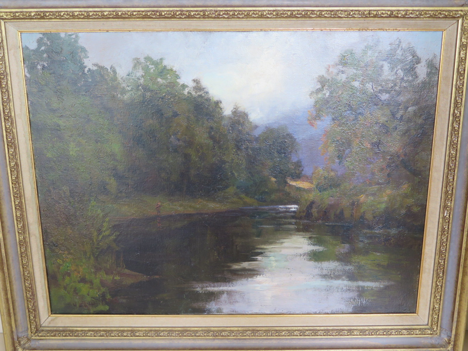 A signed oil on canvas on an angler fishing the River Tweed by H L Robinson in a gilt frame -