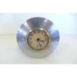 A silver desk clock with engine turned decoration, 9cm diameter, not currently running