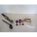 Three WWII unnamed medals with box and a bayonet and scabbard