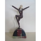 After Demetre Chiparus - An Art Deco style metal coloured marble figure of a dancer with arms