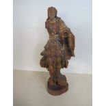 A lime wood carving with traces of original paint, probably continental on a later stand and