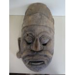 A carved Indian wooden mask, 33cm H x 23cm W - missing an ear with other losses and cracks