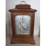 An oak cased silver dial three train Gustav Becker mantle clock, chiming on rods, 53cm tall,