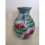 A Cobridge Lilly pattern vase, 18cm tall in good condition