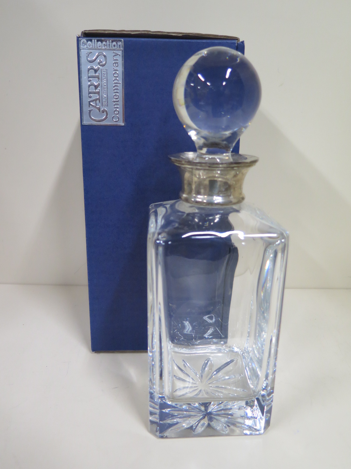 A Carrs contemporary collection, silver collared, cut glass decanter with original box, some light