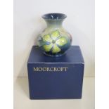 A Moorcroft Hypericum paatern vase, 9cm tall, in good condition, boxed, some crazing