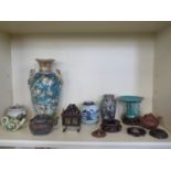 A collection of nine pieces of Oriental ware and three wooden stands and a top to include two