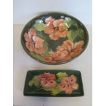 A Moorcroft bowl and pen tray in Hibiscus pattern upon green ground, approx 26cm diameter, pen