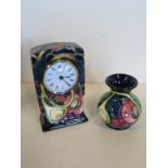 A Moorcroft Queens Choice pattern mantle clock, approx 16cm H, together with a small Moorcroft