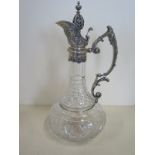 A cut glass claret jug with a silver top, marked 925 - 30cm tall, in good clean condition