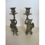 A pair of interesting brass dancing cat candlesticks, 23cm H some bending but generally good