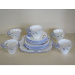 A part Shelley tea service with five tea cups, six saucers, five side plates a square serving dish