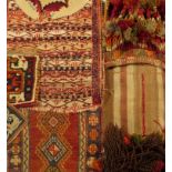 A warp faced weave saddle bag, with braided and woollen tassels, together with a Kurdish mat, a Fars