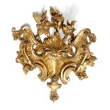 A pair of 18th century Italian giltwood corner appliques, carved with flowers, rocaille, scrolls and