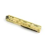 λ A Victorian novelty ivory folding ruler pencil, unmarked, with a slide-action pencil and with a